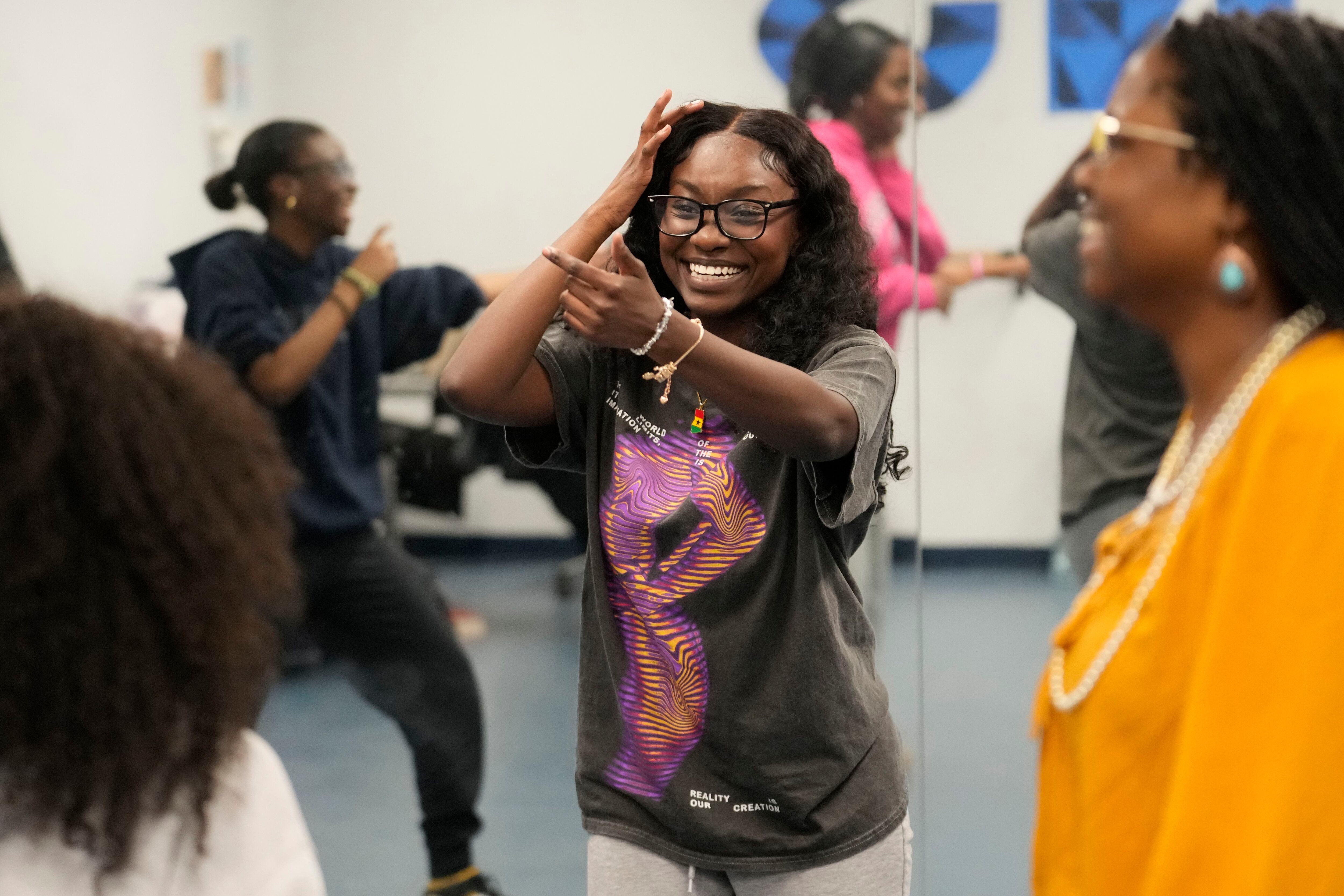 Hillary Amofa, laughs as she participates in a team building game with members of the Lincoln Park High School step team after school Friday, March 8, 2024, in Chicago. When she started writing her college essay, Amofa told the story she thought admissions offices wanted to hear. She wrote about being the daughter of immigrants from Ghana, about growing up in a small apartment in Chicago. She described hardship and struggle. Then she deleted it all. 