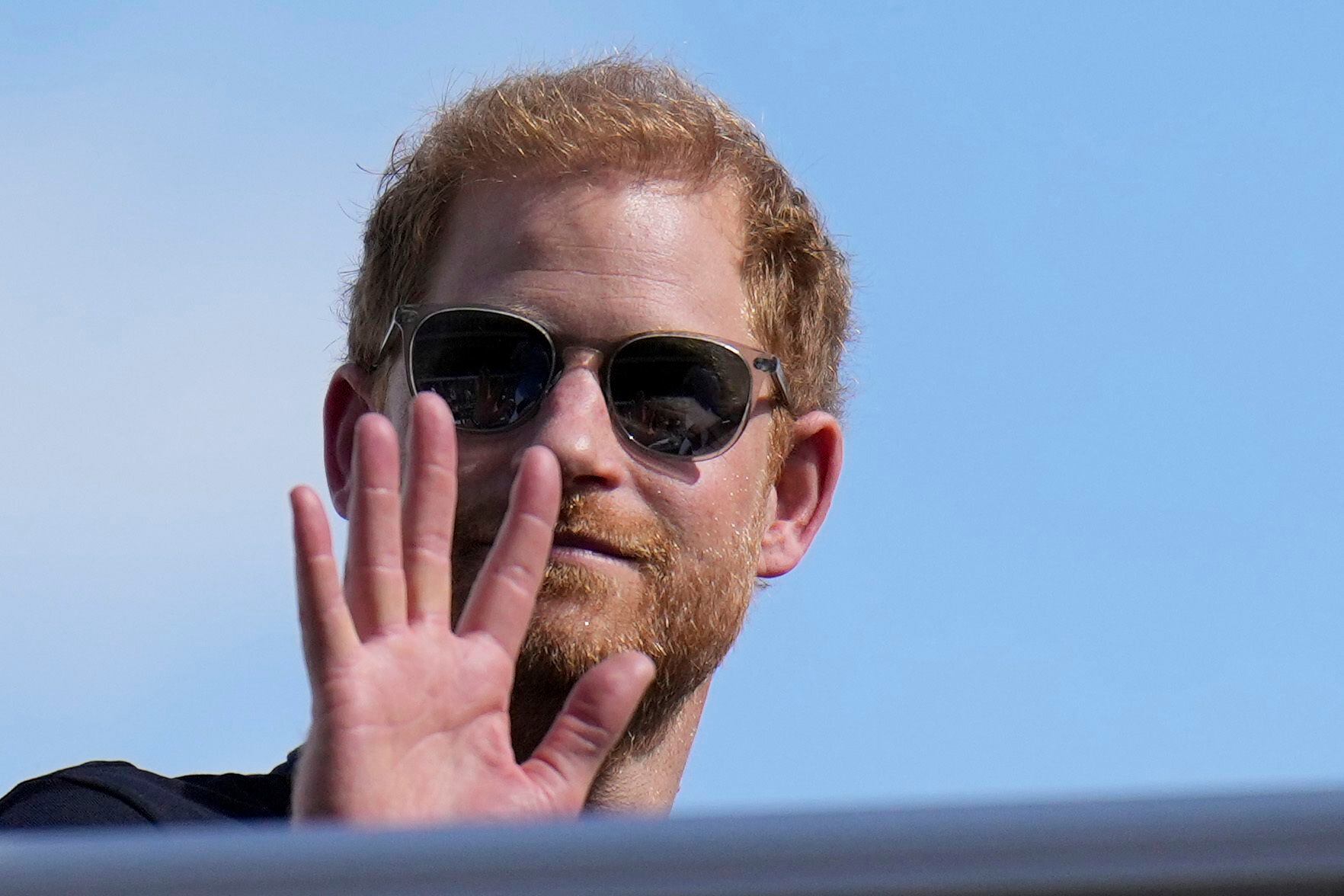 FILE - Britain's Prince Harry, the Duke of Sussex, waves during the Formula One U.S. Grand Prix auto race at Circuit of the Americas, on Oct. 22, 2023, in Austin, Texas. Prince Harry, the son of King Charles III and fifth in line to the British throne, has formally confirmed his is now a U.S. resident. Four years after Harry and his American wife, Meghan, decamped to a villa on the Southern California coast, a travel company he controls filed paperwork informing British authorities that he has moved and is now “usually resident” in the United States.