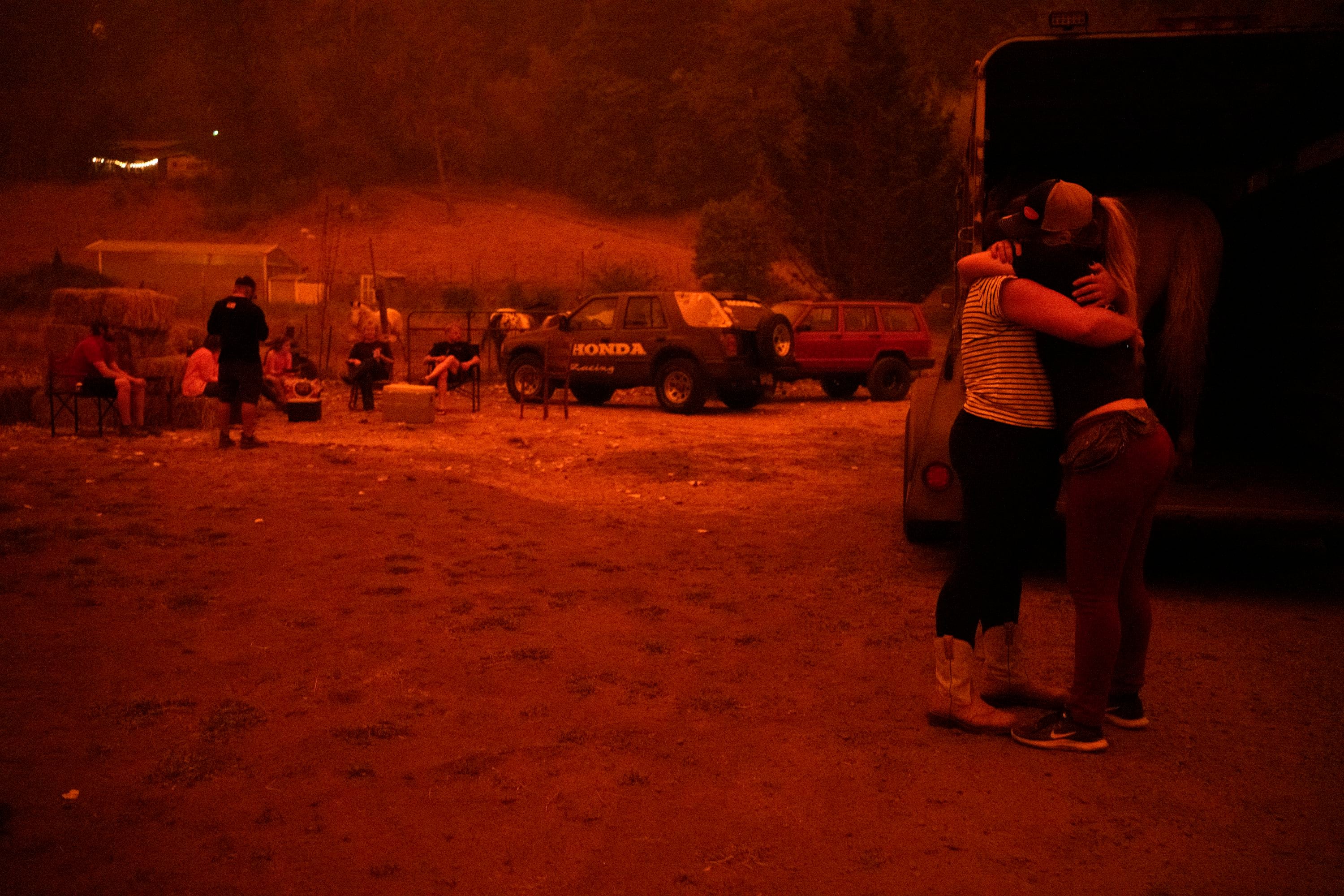 Chance Johnson hugs Sarah Hunter the two loaded a horse into a trailer to be evacuated north on Sept. 9 2020 in Canby, Oregon. Four wildfires continued gaining ground in Clackamas County aided by high winds.
