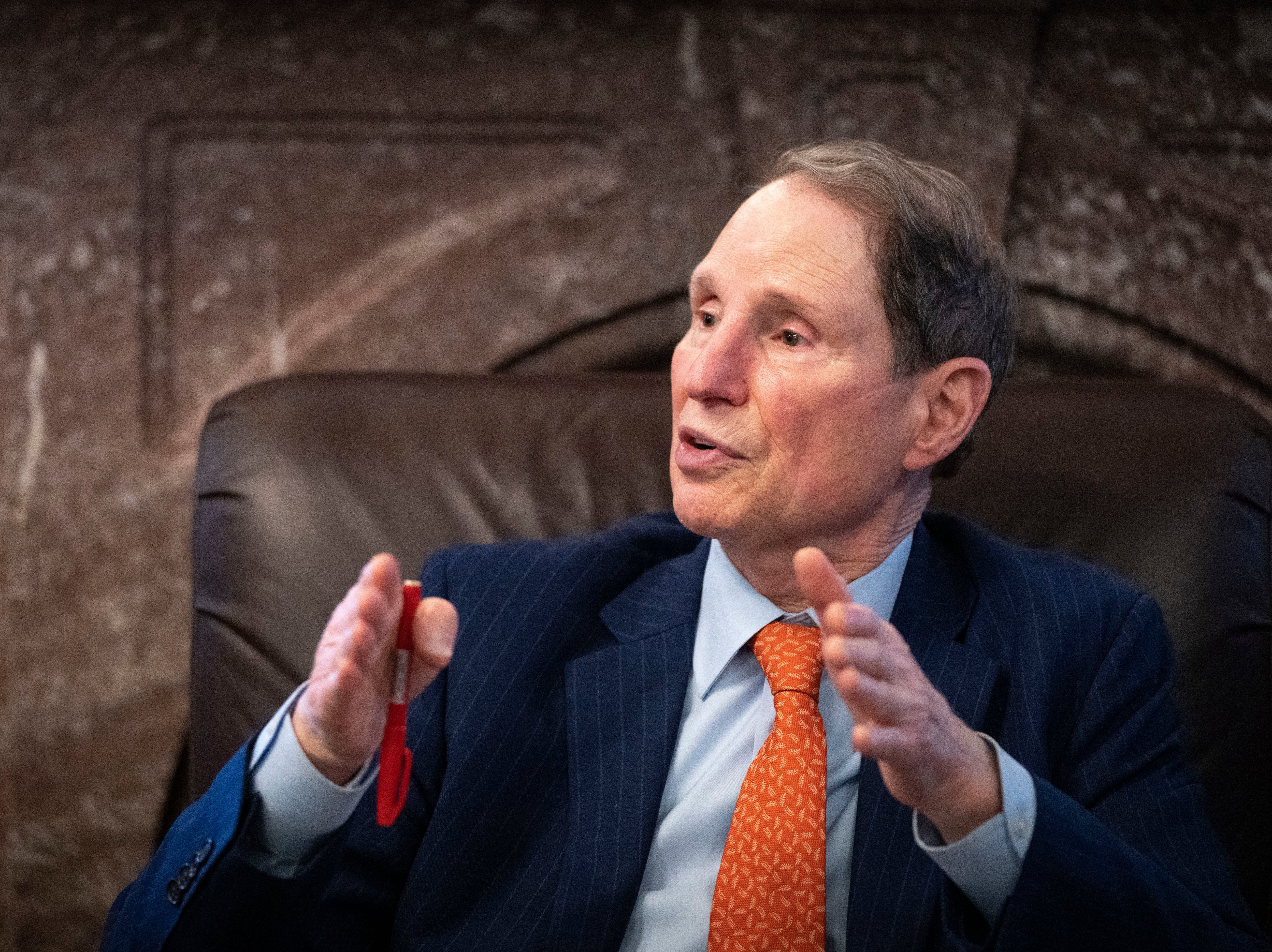 Sen. Ron Wyden, D-Oregon, speaks to reporters about a corporate minimum tax plan at the U.S. Capitol on Oct. 26 in Washington, D.C. Wyden feuded with Tesla CEO Elon Musk over the senator's proposal to tax stock investments held by billionaires annually.