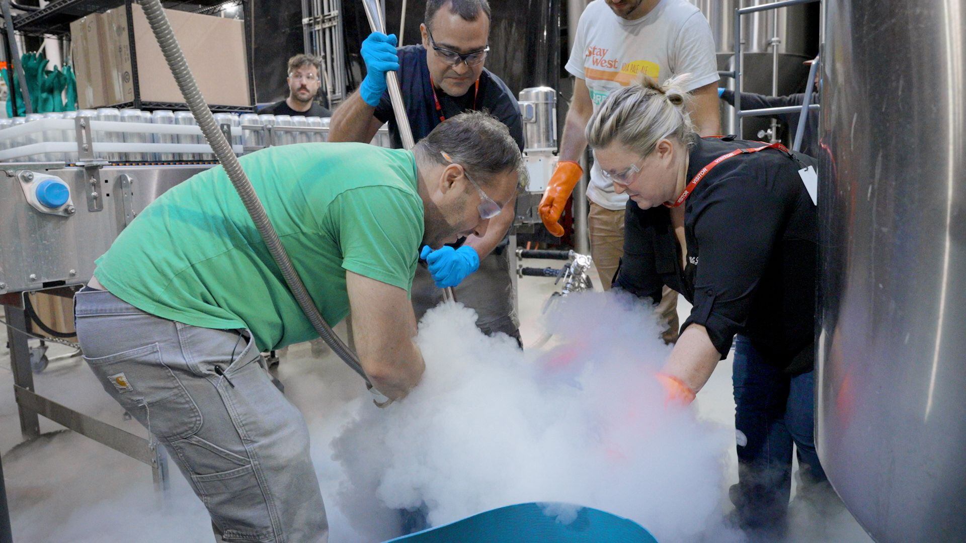 Brewmaster Ben Edmunds of Breakside Brewery pours liquid nitrogen onto freshly picked hops in Milwaukie, Ore., on Sept. 14, 2023.