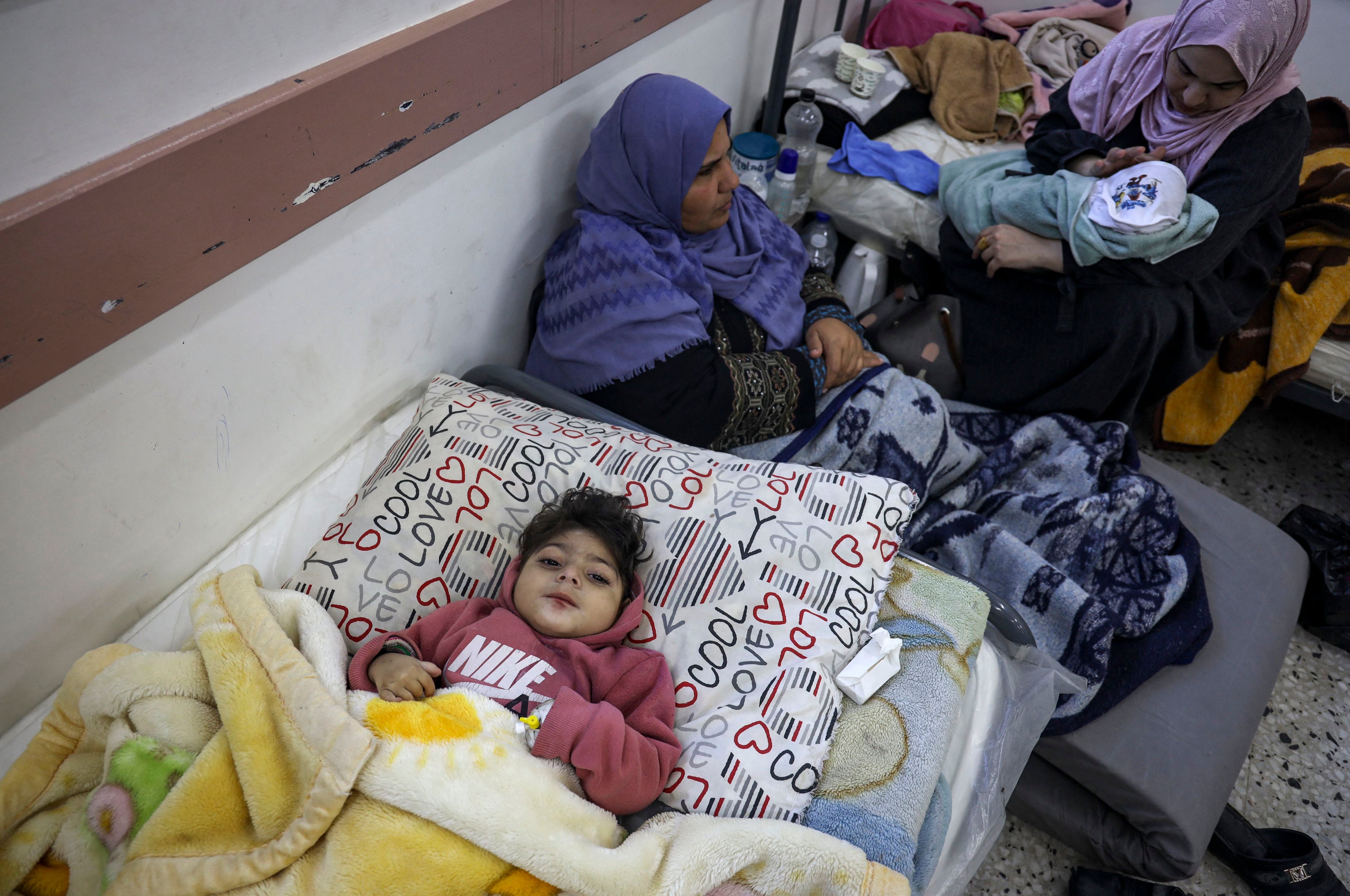 Palestinian women and infants receive medical care at a clinic in Rafah, in the southern Gaza Strip, on Feb. 29.