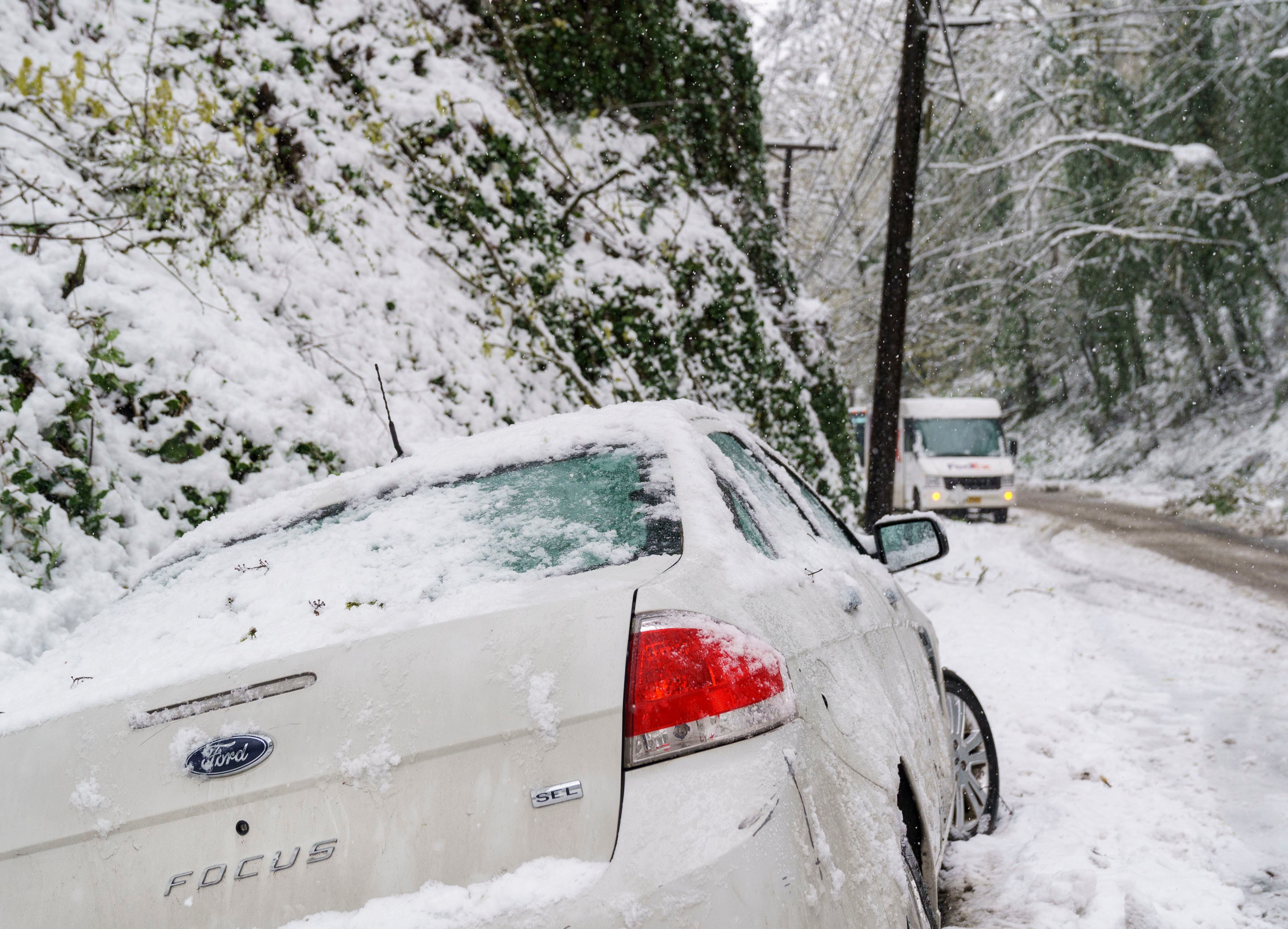 An abandoned vehicle sits in a ditch in this April 11, 2022, file photo from West Burnside Road in Portland. Drivers should be prepared this week for dangerous road conditions as forecasters say the weather is expected to be extremely cold on Thursday and Friday with a likelihood of snow or freezing rain.