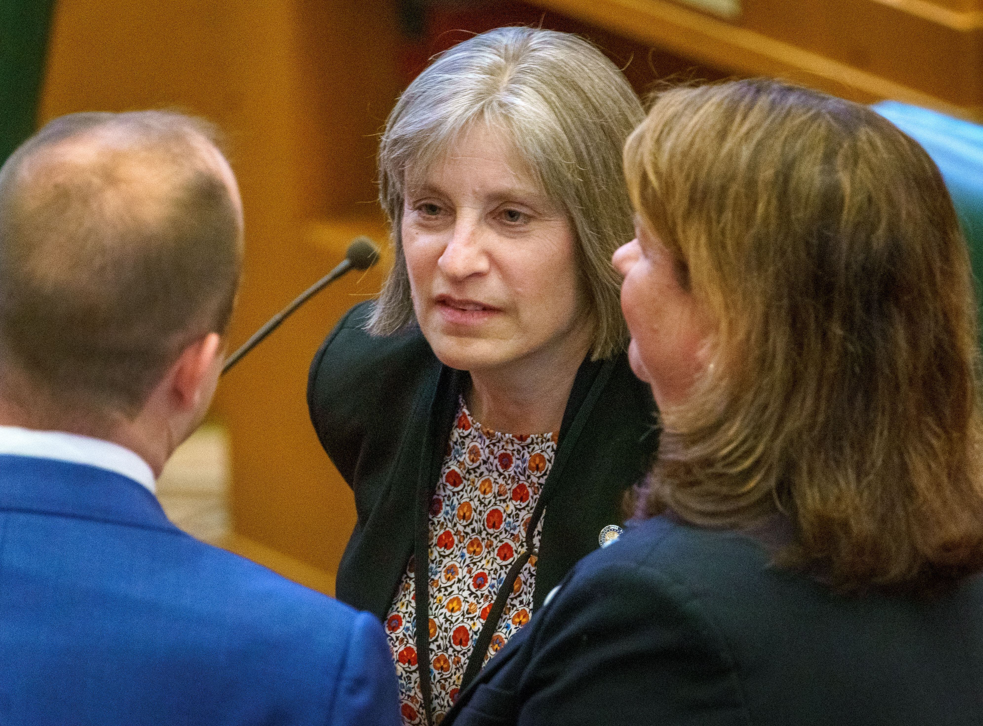 FILE: Oregon state Rep. Lisa Reynolds, D-Northeast Washington County, confers with colleagues on Feb. 5, 2024, during the opening of the legislative short session at the Oregon state Capitol in Salem, Ore. Reynolds is a pediatrician and the chair of the House Committee on Early Childhood and Human Services.
