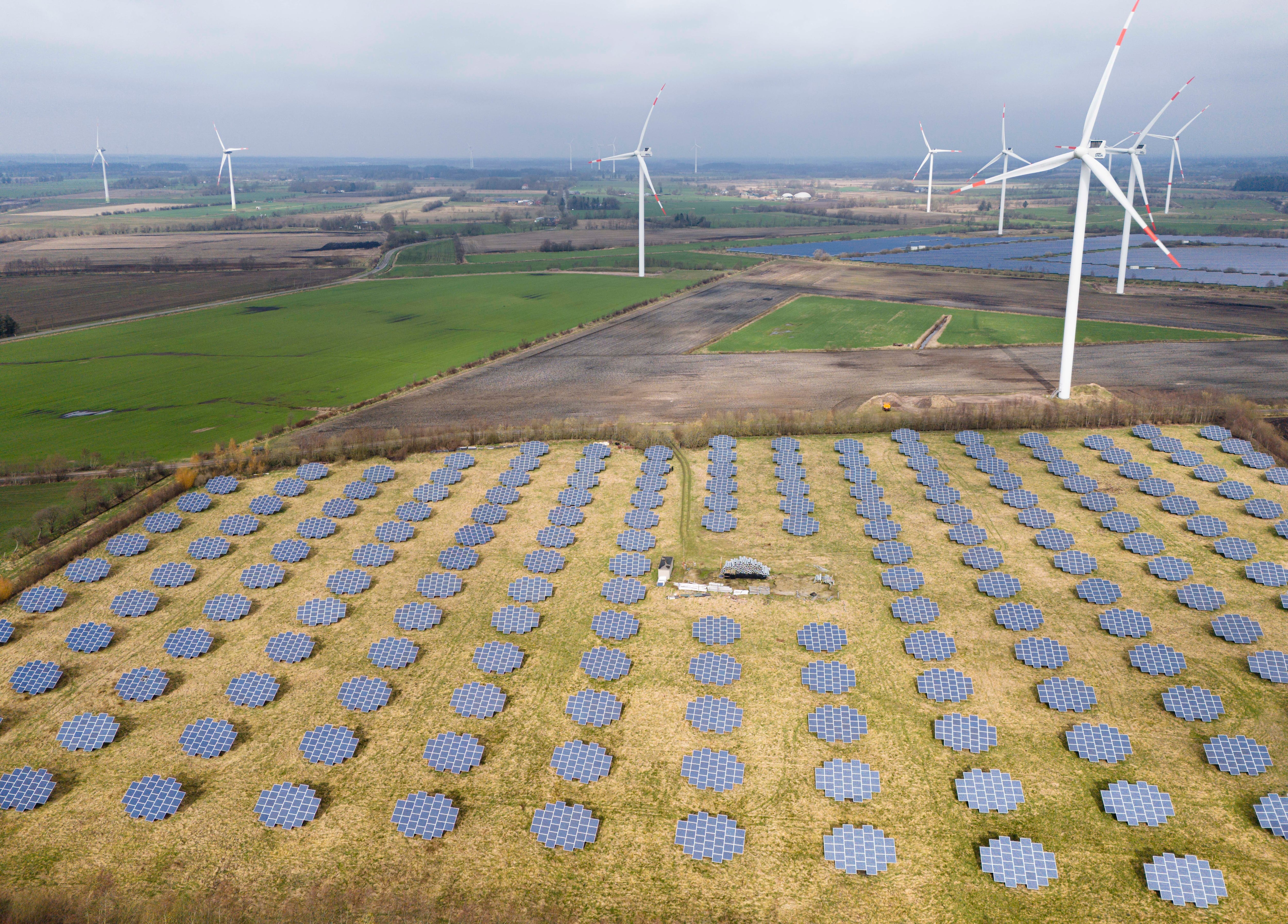 FILE - Solar panels stand on the edge of a wind farm in Sprakebuell, Germany, on Thursday, March 14, 2024. Three Oregon state lawmakers will go to Denmark in April to learn more about the production of hydrogen gas and biogas, a fuel created through the breakdown of organic matter.